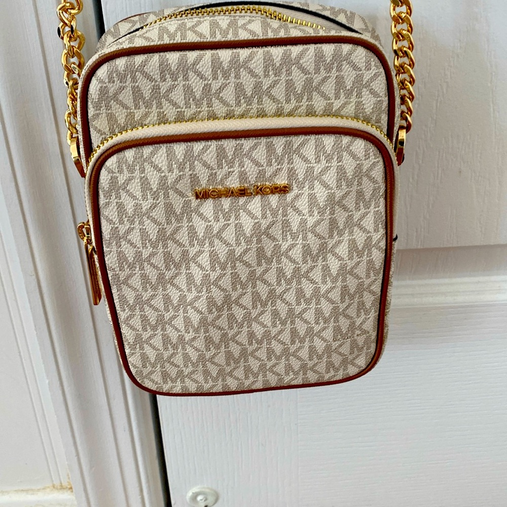Michael Kors white and brown crossbody with signature monogram MK.